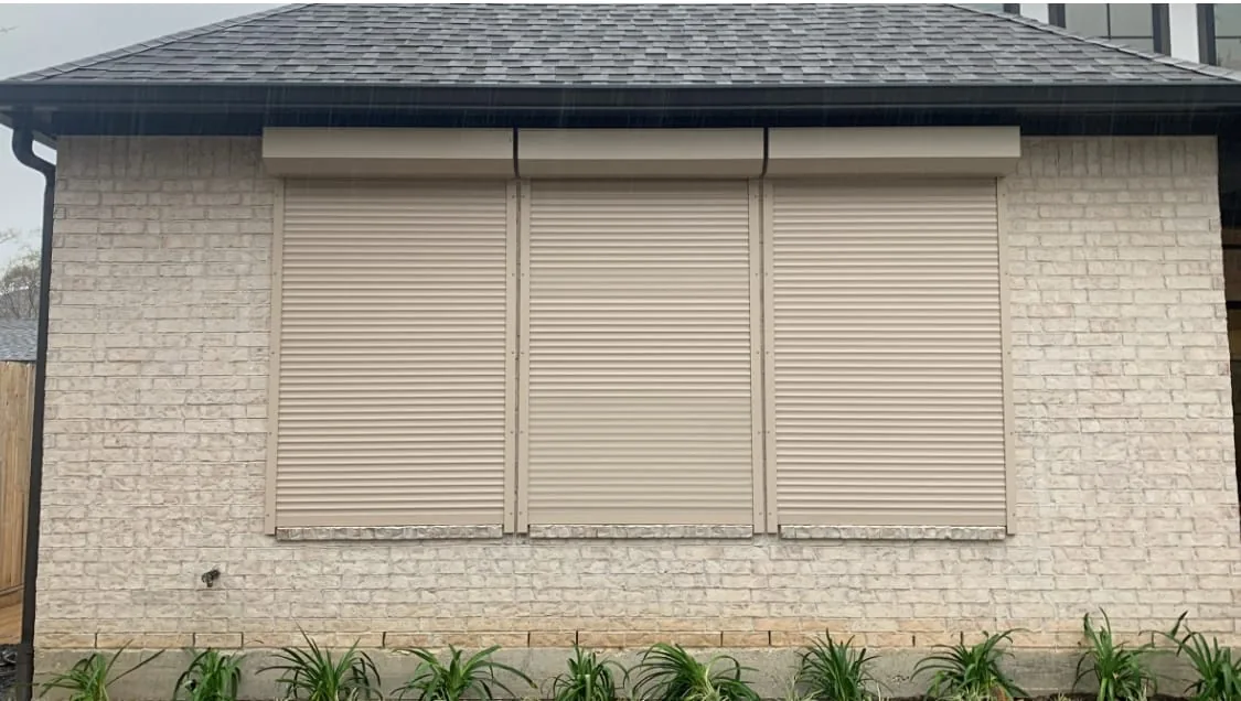 Bronze exterior shutters on a stone home