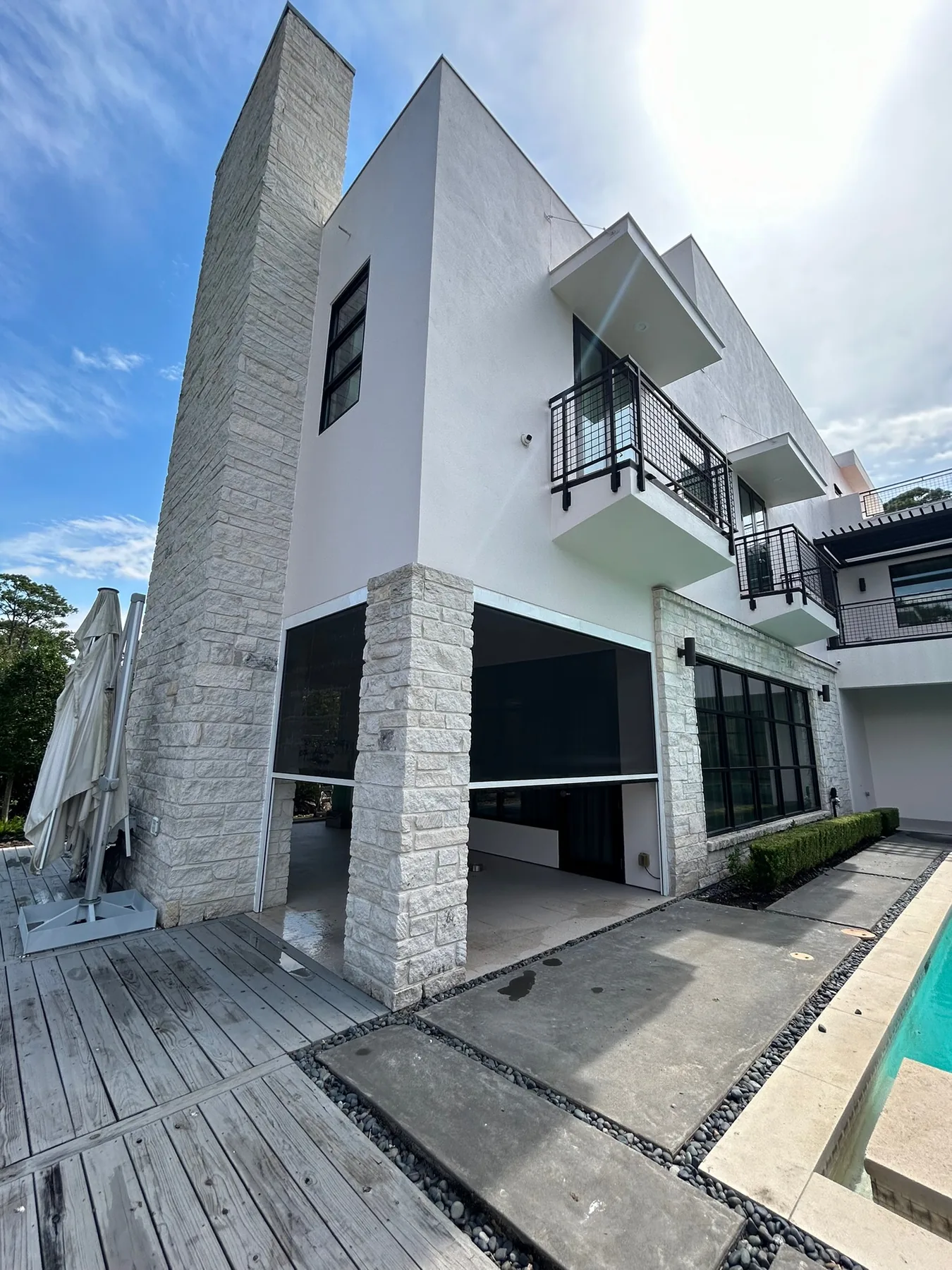 Exterior shades enclosing a modern pool house