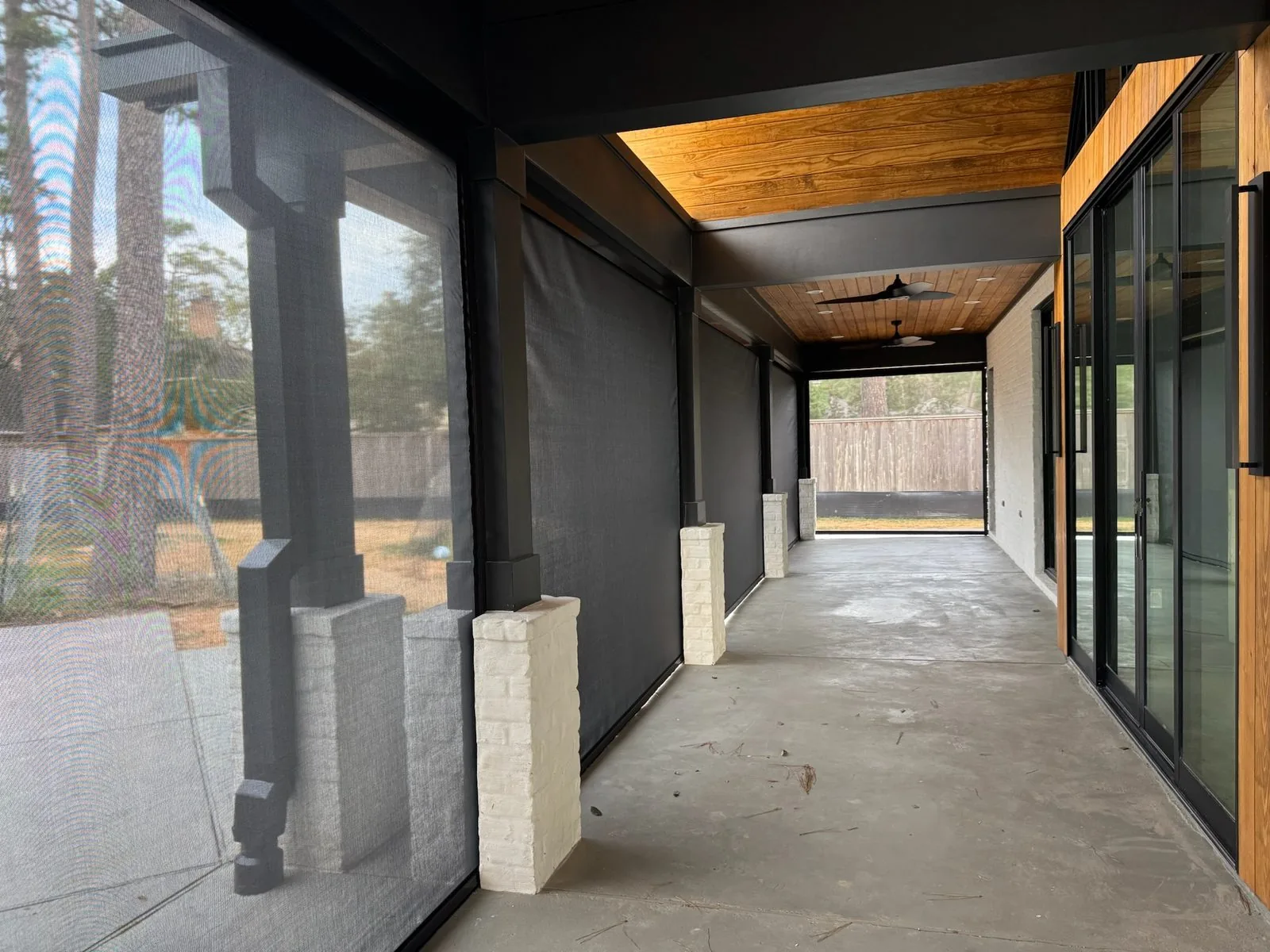 Modern covered walkway with dark exterior shades