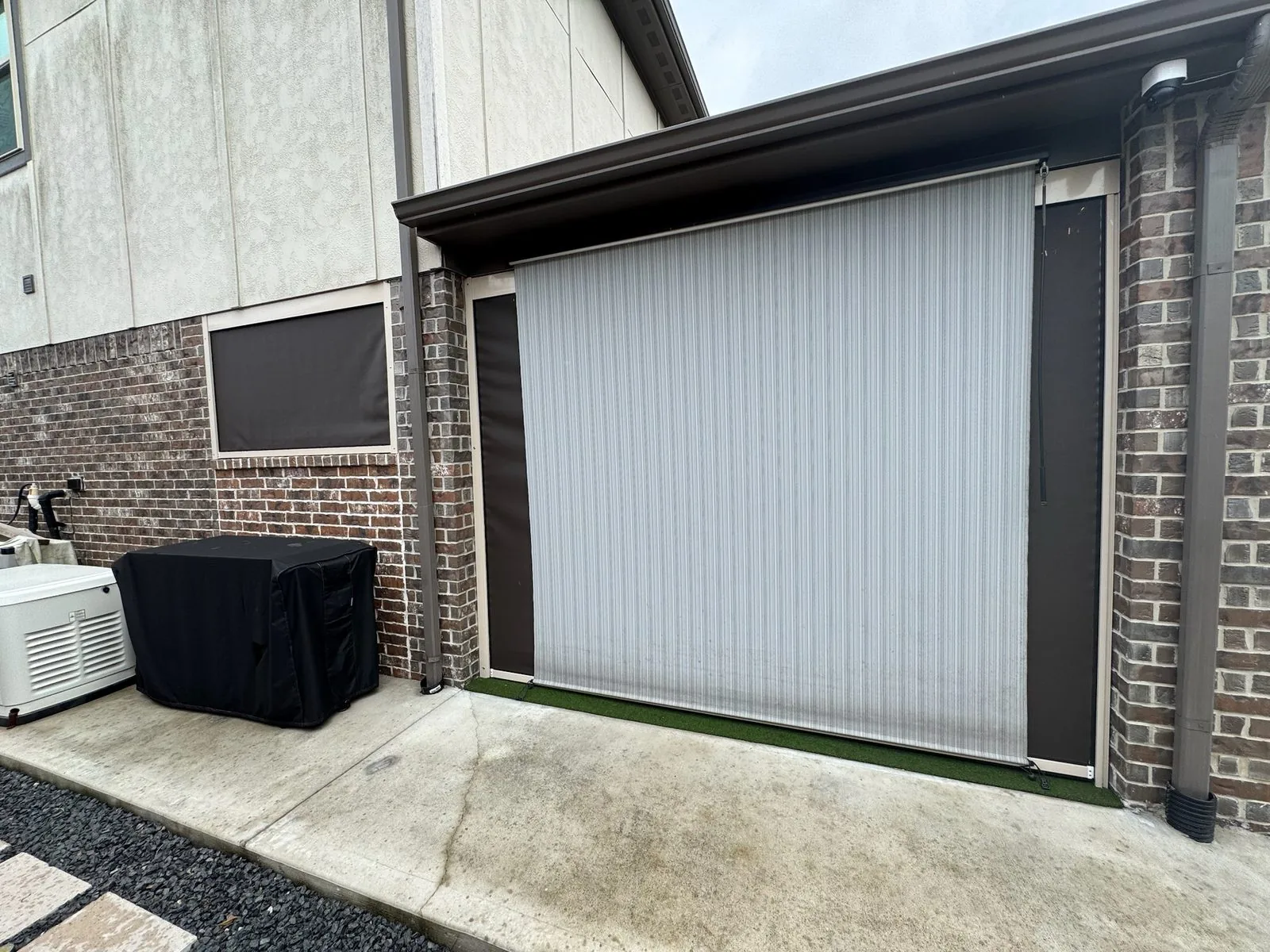 Two-story home with large light gray drop shade