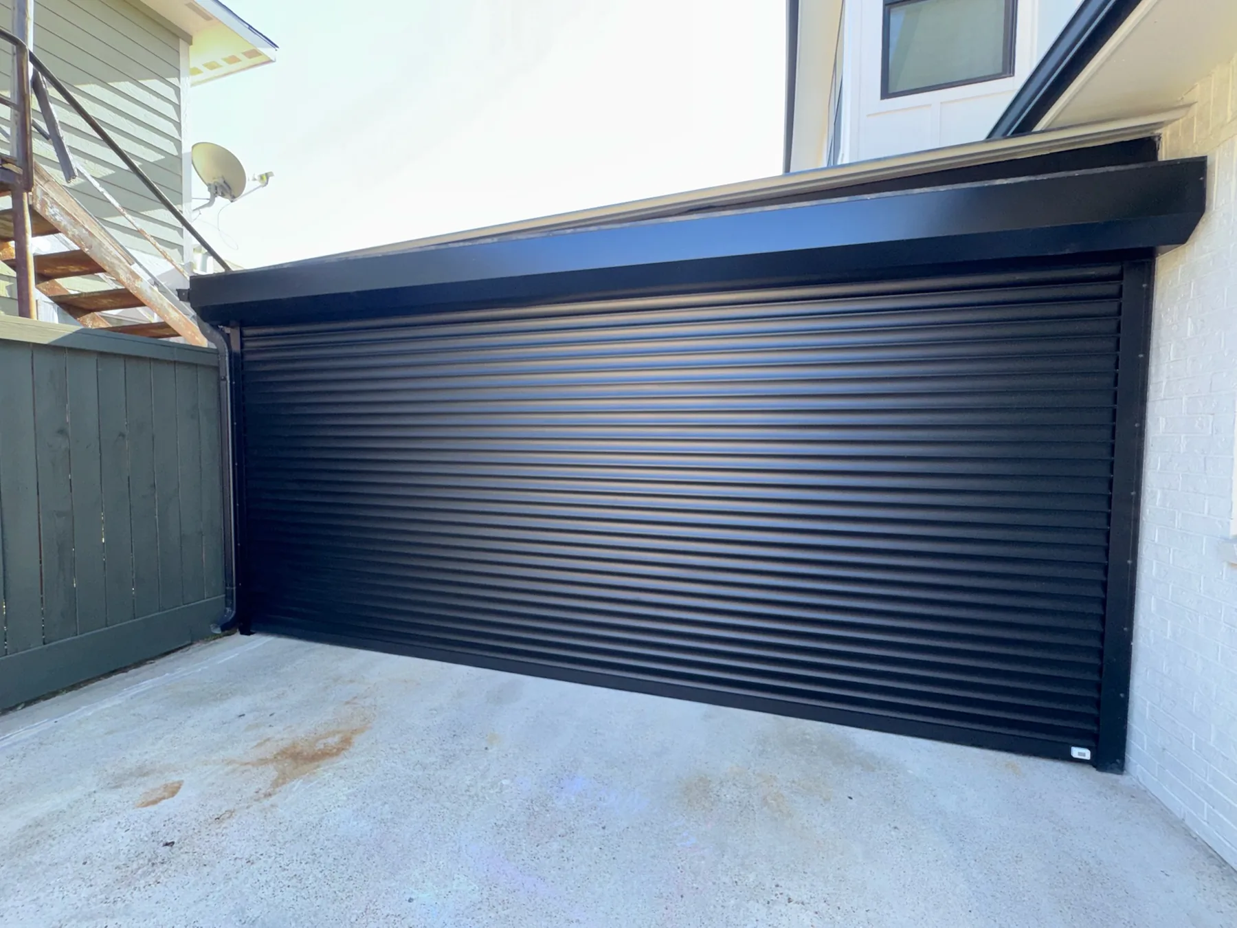 Black roll-up garage door on a contemporary residence
