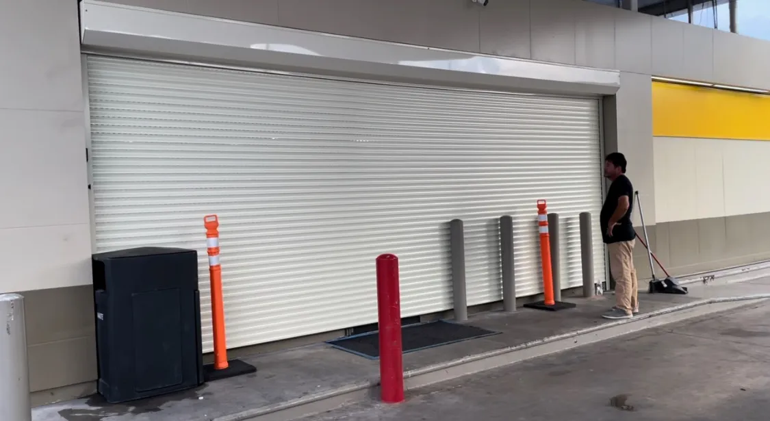 White TMAX roll-up door installed at a commercial service opening