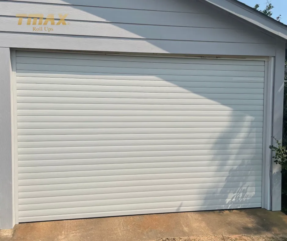 White TMAX roll-up garage door on a detached residential garage