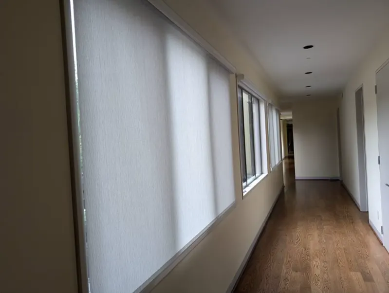 TMAX interior shades providing filtered light along a residential hallway