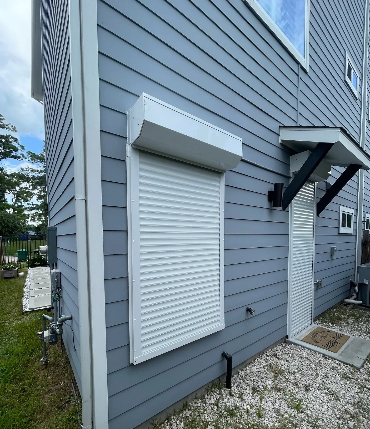 White roll-down shutters protecting a residential patio